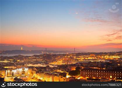 Cityscape of Lisbon at dusk with new moon in the sky. Portugal