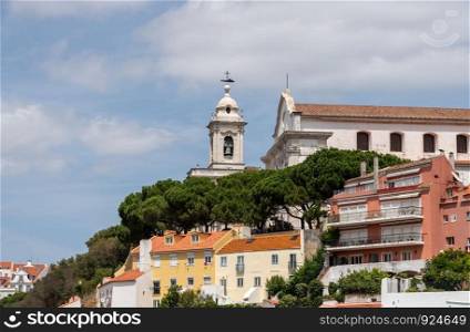 Cityscape of Lisbon with bell tower of the Graca church in the Alfama district. Bell tower of Graca church in Alfama district of Lisbon