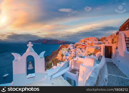 Cityscape of Oia town in Santorini island, Greece. Panoramic view at the sunset.