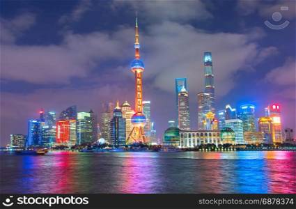 Cityscape of Shanghai Downtown at night with reflection in the river