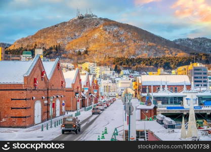 Cityscape of the historic red brick warehouses and Mount Hakodate  at twilight in Hakodate, Hokkaido Japan in winter