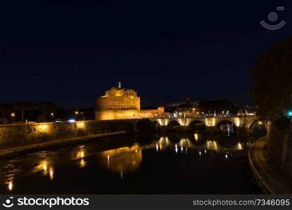 Cityscape romantic night view of Roma. Panorama with Saint Angelo castle and bridge. Famous tourist destination with Tiber. Travel illuminated landscape in Italy, Europe.