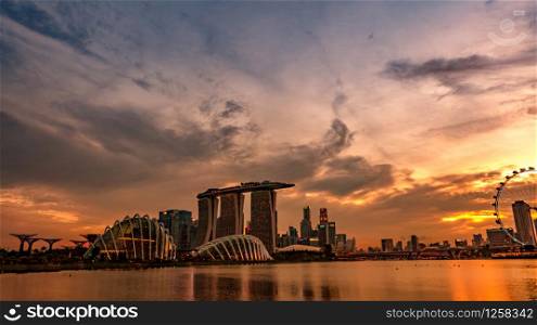 Cityscape Singapore modern and financial city in Asia. Marina bay landmark of Singapore. Landscape of business building and hotel. Panorama view of Marina bay with sunset sky.