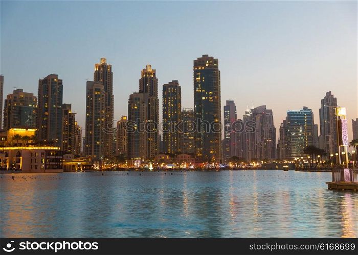cityscape, travel, tourism and urban concept - Dubai business city district night lights and seafront