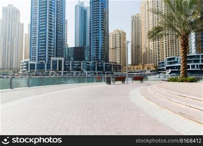 cityscape, travel, tourism and urban concept - Dubai city business district skyscrapers and seafront
