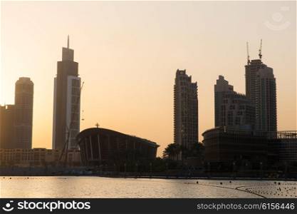 cityscape, travel, tourism and urban concept - Dubai city business district skyscrapers and seafront at evening