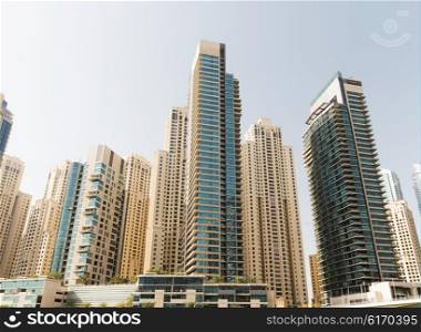 cityscape, travel, tourism and urban concept - Dubai city business district with skyscrapers