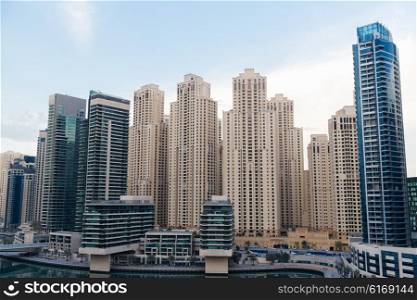 cityscape, travel, tourism and urban concept - Dubai city business district with skyscrapers and bridge