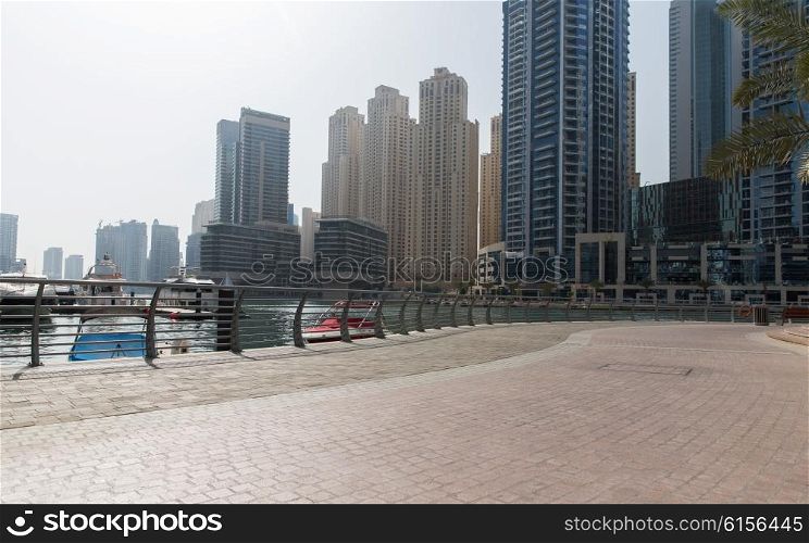 cityscape, travel, tourism and urban concept - Dubai city seafront or harbor with boats