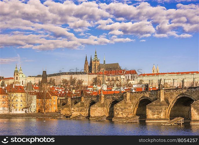 Cityscape with St. Vitus Cathedral in background and the Charles Bridge in foreground, under a beautiful sky. Picture captured in Prague, Czech Republic