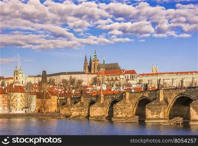 Cityscape with St. Vitus Cathedral in background and the Charles Bridge in foreground, under a beautiful sky. Picture captured in Prague, Czech Republic