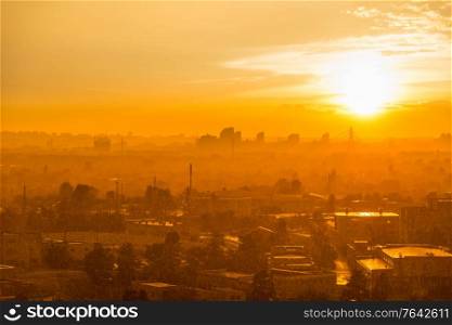 Cityscape with sunset in big city, moderm buildings under dramatic sunset sky