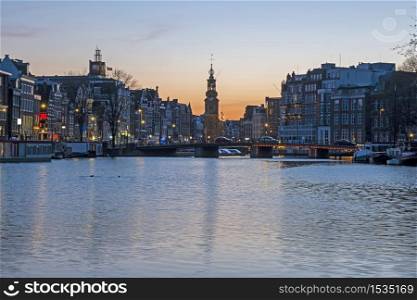 Cityscenic from Amsterdam in the Netherlands with the Munt tower at sunset