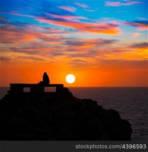 Ciutadella Menorca at Punta Nati orange sunset with girl backlight