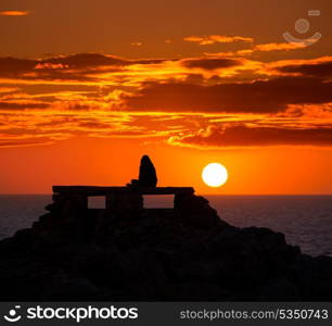 Ciutadella Menorca at Punta Nati orange sunset with girl backlight