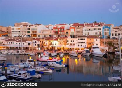 Ciutadella Menorca marina Port sunset with boats and streetlights in Balearic islands