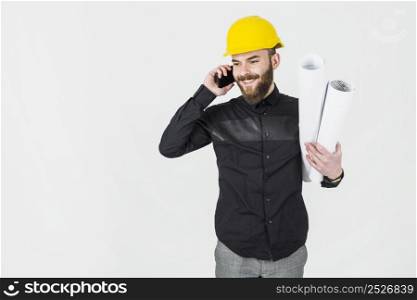 civil engineer holding blueprint his hand talking cellphone