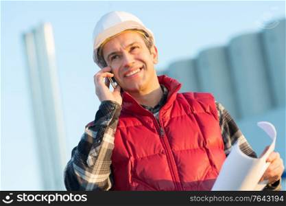 civil engineer talking on smartphone outdoors