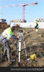 Civil engineers on site with surveying equipment
