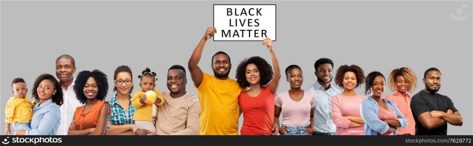 civil rights, equality and anti-racism protest concept - group of happy smiling african american people with black lives matter banner over grey background. african people with black lives matter banner