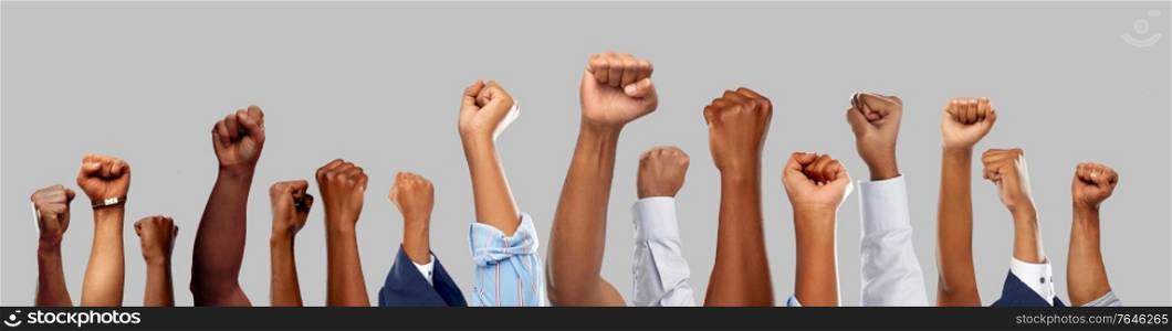 civil rights, equality and power concept - african american male hands showing fists over grey background. african american male hands showing fists