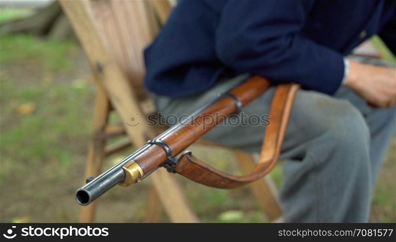 Civil War soldier cleans his rifle
