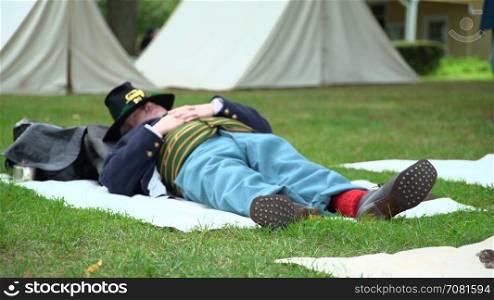 Civil War soldier napping in camp