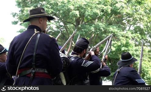 Civil War soldiers firing guns in formation