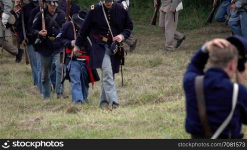 Civil War soldiers marching across field