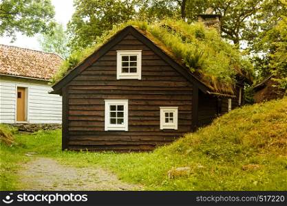 Civilization and nature concept. Norwegian cottage House roof covered with beautiful green moss. House roof covered with moss