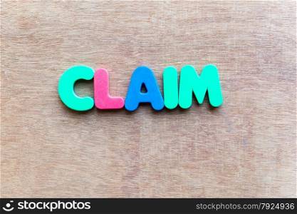 claim colorful word in the wooden background