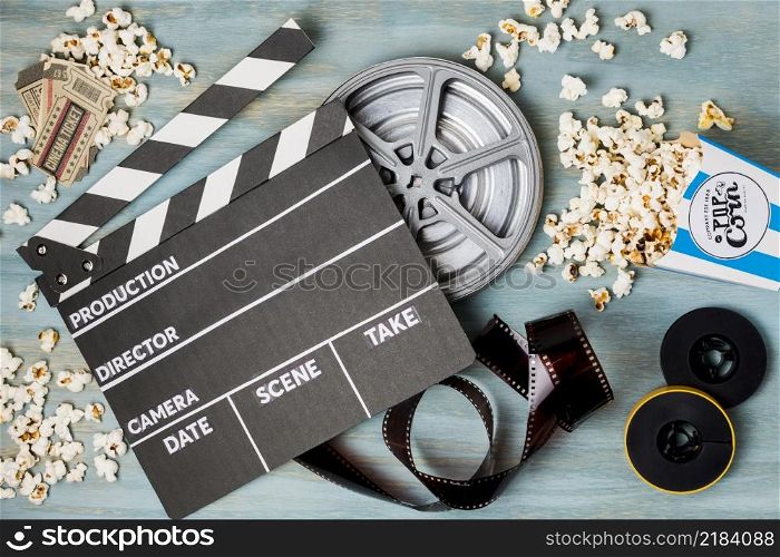 clapperboard popcorn film stripe cinema tickets wooden desk