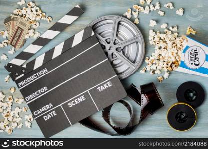 clapperboard popcorn film stripe cinema tickets wooden desk