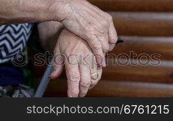 Clasped senior woman hands