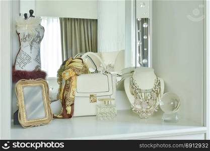 Classic bag and beautiful necklace on white color dressing table