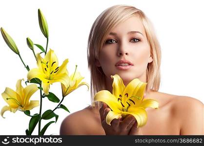 classic beauty portrait of a young and pretty girl with blond hair naked shoulder offering a yellow lily over white