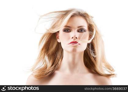 classic beauty portrait of young sexy girl with hairstyle and flying hair from wind, she is in front the camera looks in to the lens with searious expression