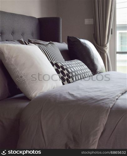 Classic bedroom interior with pillows next to the window