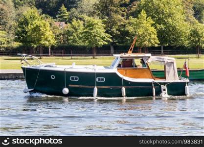 Classic boat cruising on the River Thames at Henley on Thames, Berkshire, England