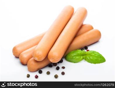 Classic boiled meat pork sausages with pepper and basil on white.