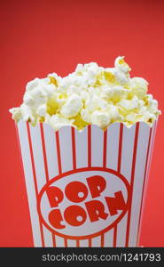 Classic box cinema popcorn on red background