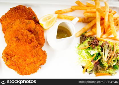 classic breaded Milanese veal cutlets with french fries and vegetables on background ,MORE DELICIOUS FOOD ON PORTFOLIO