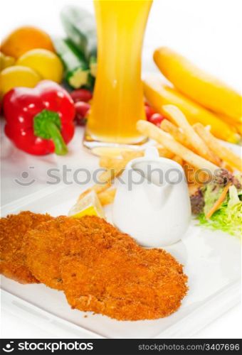 classic breaded Milanese veal cutlets with french fries , vegetables and glass of lager beer on background ,MORE DELICIOUS FOOD ON PORTFOLIO