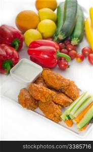classic buffalo chicken wings served with fresh pinzimonio and vegetables on background,MORE DELICIOUS FOOD ON PORTFOLIO