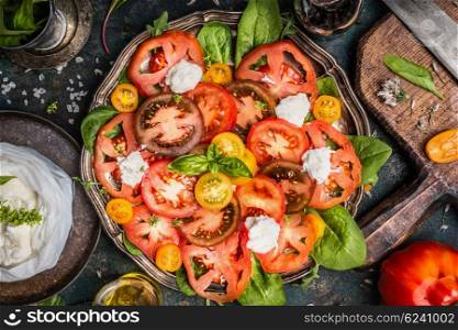 Classic caprese salad with tomatoes and mozzarella , top view, close up. Italian food concept