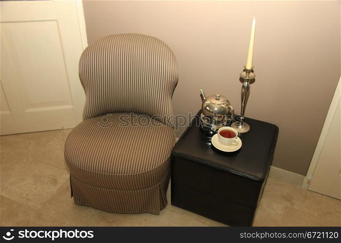 Classic chair and still life of living room accessoiries in silver