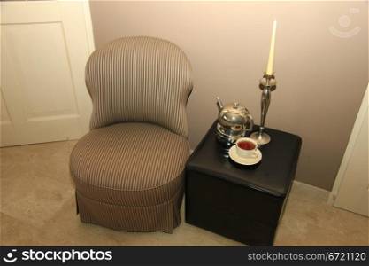 Classic chair and still life of living room accessoiries in silver