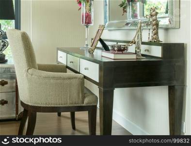 classic chair with jewelry set on wooden dressing table