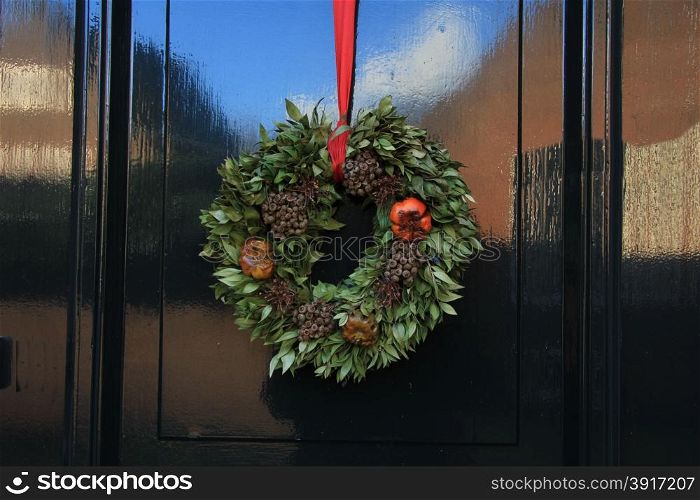 Classic christmas wreath with decorations on a door