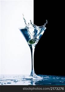 classic contemporary cocktail with splashes on black and white background. contemporary cocktail with splashes
